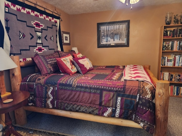 bedroom featuring a textured ceiling and carpet flooring