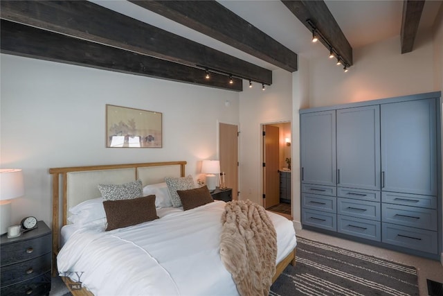 bedroom with carpet floors, a high ceiling, visible vents, beam ceiling, and rail lighting