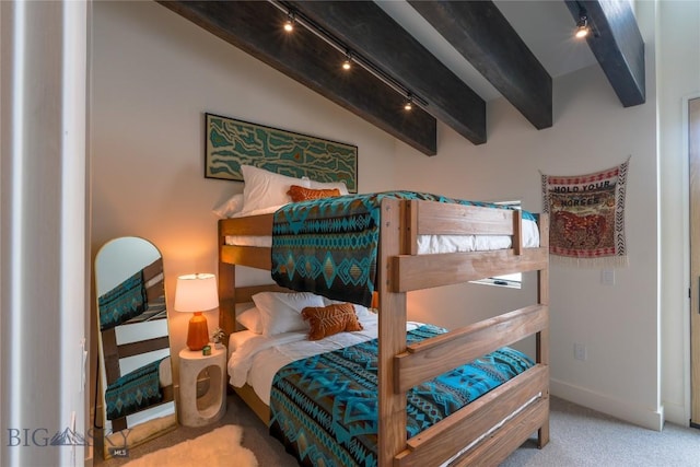 bedroom with carpet floors, vaulted ceiling with beams, and baseboards