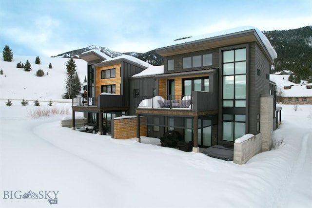 view of snow covered rear of property