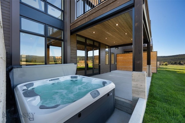 view of patio / terrace with a hot tub