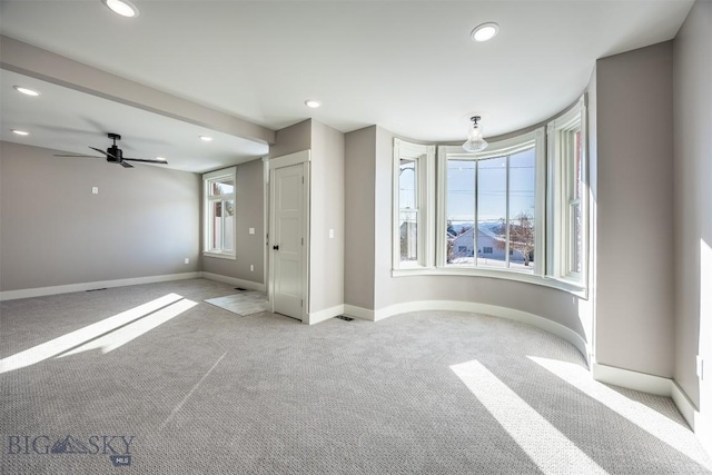 unfurnished room featuring light carpet, ceiling fan, baseboards, and recessed lighting