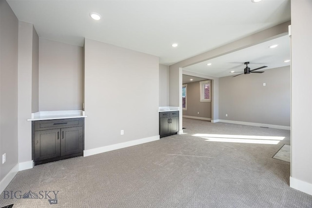 unfurnished living room with light carpet and baseboards