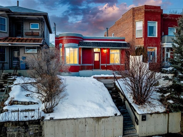 view of front of property featuring stairs and brick siding