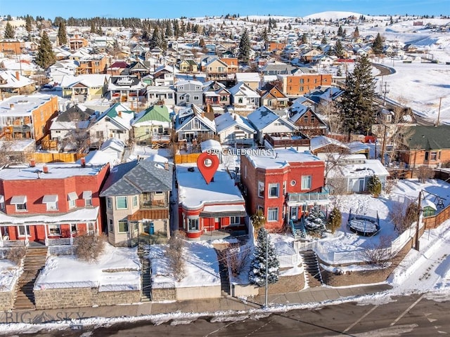 snowy aerial view with a residential view