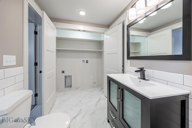 bathroom with toilet, marble finish floor, recessed lighting, and vanity