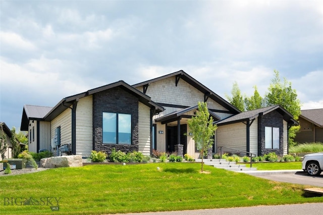 craftsman inspired home featuring stone siding, metal roof, and a front yard