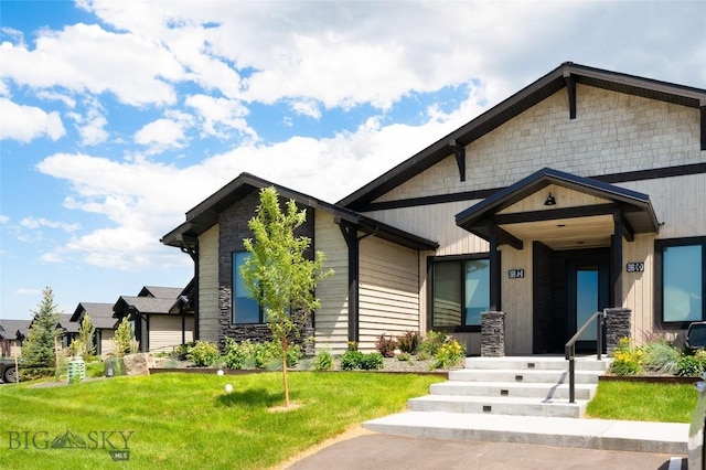 view of front of home with stone siding and a front yard