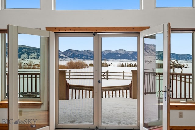 entryway featuring plenty of natural light, french doors, and a mountain view