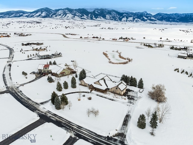 snowy aerial view with a mountain view