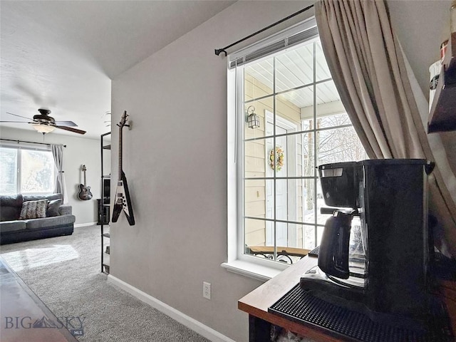 interior space featuring carpet floors, ceiling fan, and baseboards