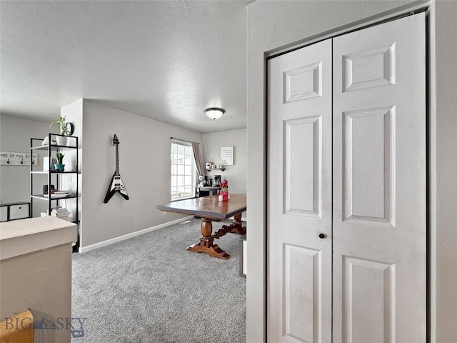 carpeted home office with baseboards