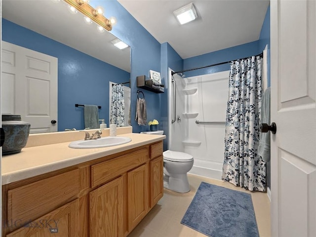 full bath featuring a shower stall, vanity, and toilet