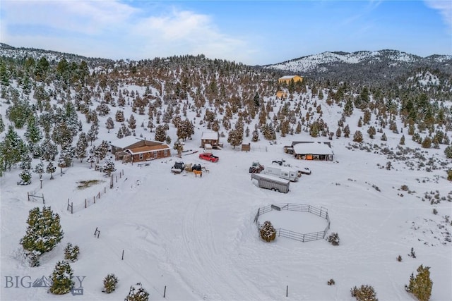 snowy aerial view with a mountain view