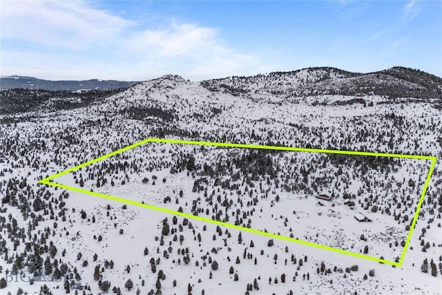 snowy aerial view with a mountain view