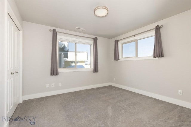 500 Westgate, Bozeman, MT 59718 - unfurnished bedroom featuring carpet, multiple windows, and baseboards