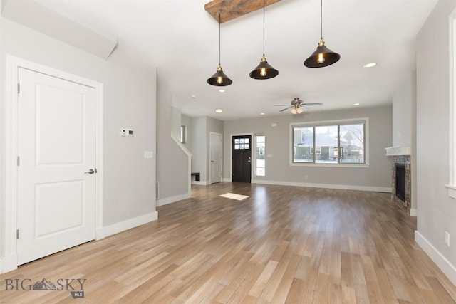500 Westgate, Bozeman, MT 59718 - unfurnished living room with light wood-style floors, baseboards, a fireplace, ceiling fan, and recessed lighting