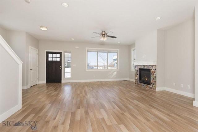 500 Westgate, Bozeman, MT 59718 - unfurnished living room with a ceiling fan, light wood finished floors, a stone fireplace, recessed lighting, and baseboards
