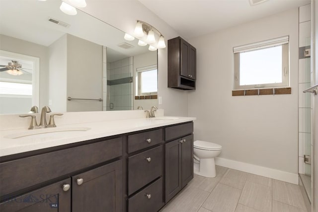 500 Westgate, Bozeman, MT 59718 - full bath with a stall shower, toilet, double vanity, baseboards, and a ceiling fan