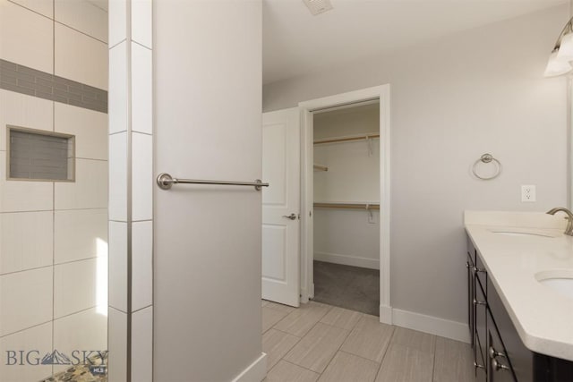 500 Westgate, Bozeman, MT 59718 - bathroom with double vanity, baseboards, and a spacious closet