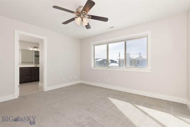500 Westgate, Bozeman, MT 59718 - unfurnished bedroom with light carpet, baseboards, connected bathroom, and ceiling fan