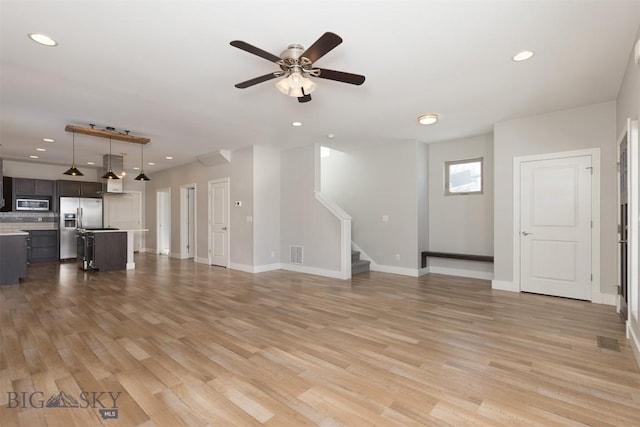 500 Westgate, Bozeman, MT 59718 - unfurnished living room with stairway, light wood-type flooring, a ceiling fan, baseboards, and recessed lighting
