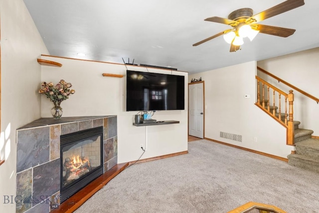 1014 Idaho St, Belgrade, MT 59714 - unfurnished living room with carpet flooring, stairs, ceiling fan, and a fireplace