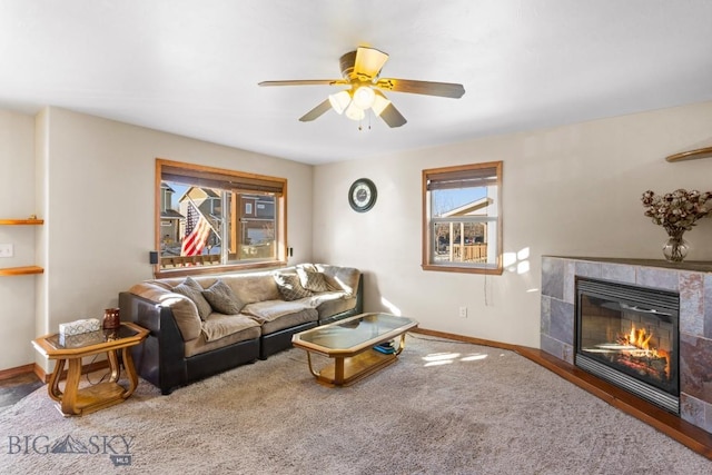 1014 Idaho St, Belgrade, MT 59714 - living room featuring ceiling fan, a tile fireplace, and carpet