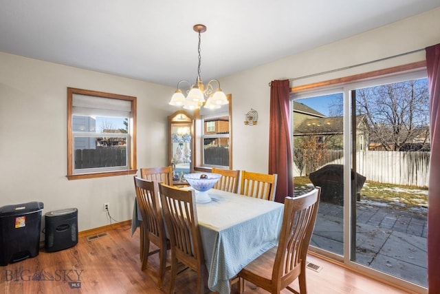 1014 Idaho St, Belgrade, MT 59714 - dining room with wood finished floors and a chandelier
