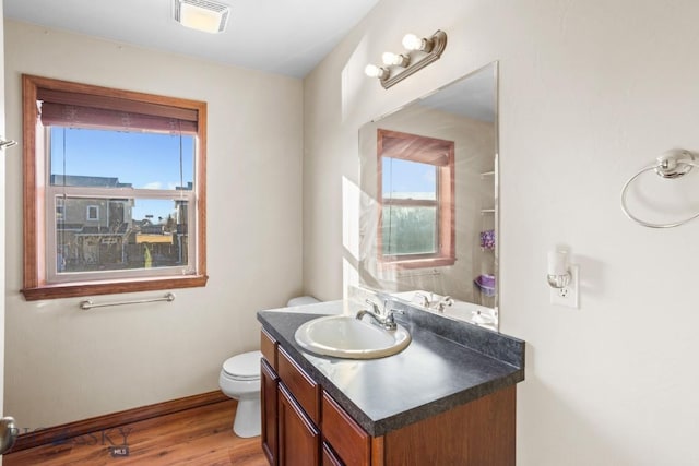 1014 Idaho St, Belgrade, MT 59714 - bathroom with healthy amount of natural light, vanity, and wood finished floors