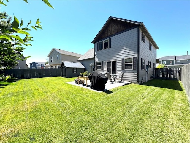 1014 Idaho St, Belgrade, MT 59714 - rear view of property featuring a shed, a fenced backyard, a patio area, and board and batten siding
