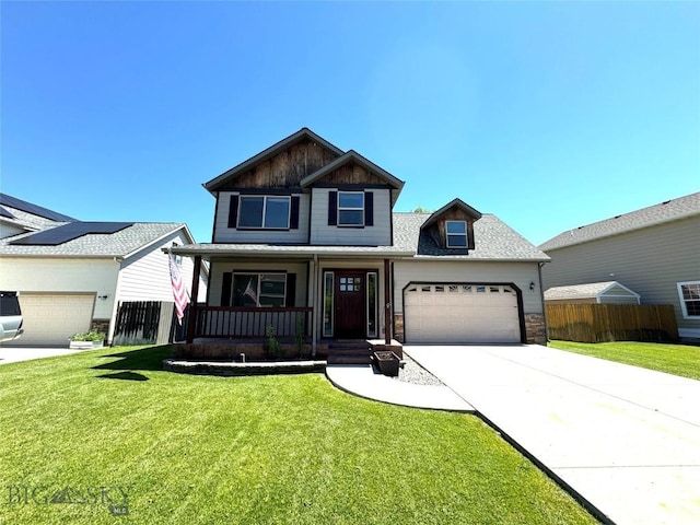 1014 Idaho St, Belgrade, MT 59714 - view of front of house with covered porch, concrete driveway, and a garage