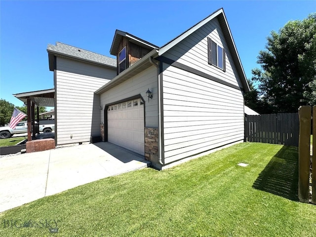 1014 Idaho St, Belgrade, MT 59714 - view of home's exterior featuring concrete driveway, an attached garage, and stone siding