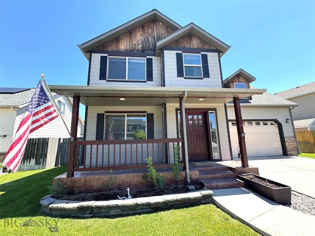 1014 Idaho St, Belgrade, MT 59714 - view of front facade featuring covered porch, an attached garage, and concrete driveway