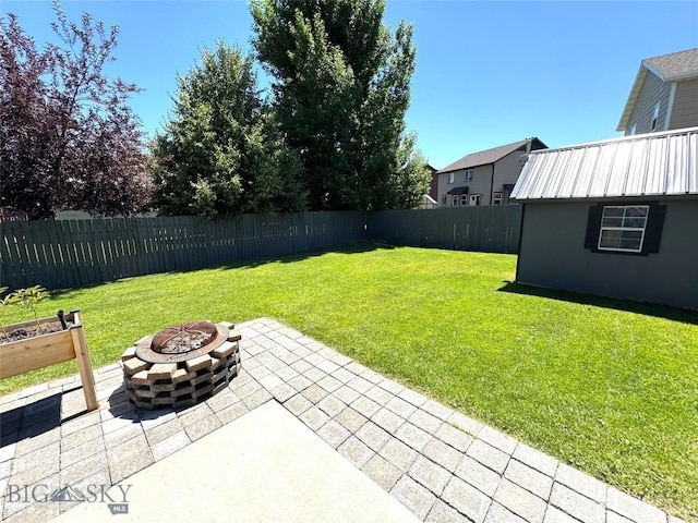 1014 Idaho St, Belgrade, MT 59714 - fenced backyard with an outdoor fire pit and a patio