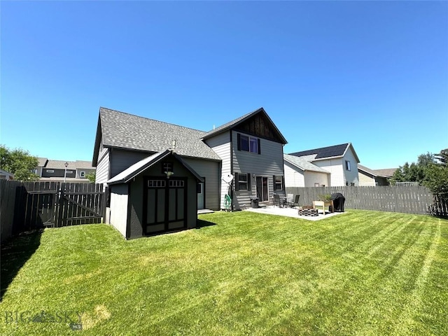 1014 Idaho St, Belgrade, MT 59714 - rear view of property with a patio area, a fenced backyard, and roof with shingles
