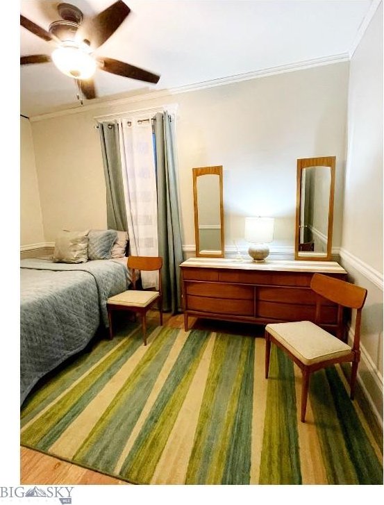 bedroom with ceiling fan and crown molding