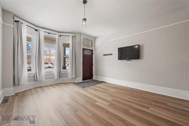 entrance foyer featuring wood finished floors, visible vents, and baseboards