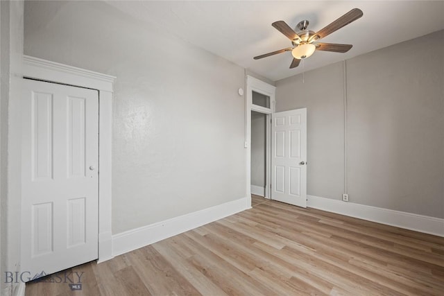 unfurnished room featuring baseboards, ceiling fan, and light wood finished floors