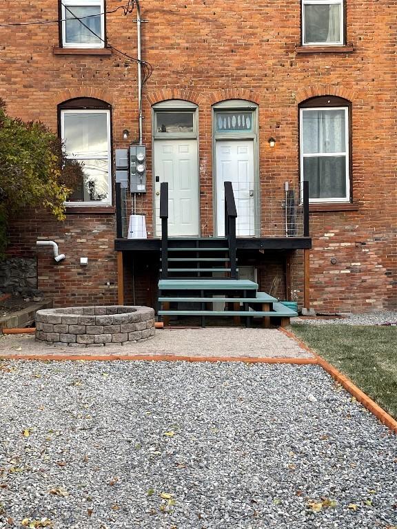view of exterior entry featuring brick siding