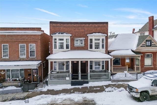 view of front of property featuring a porch and brick siding