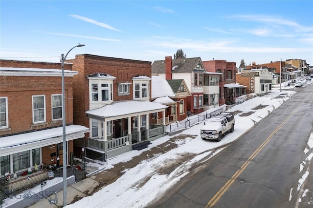 view of front of house with a residential view and brick siding