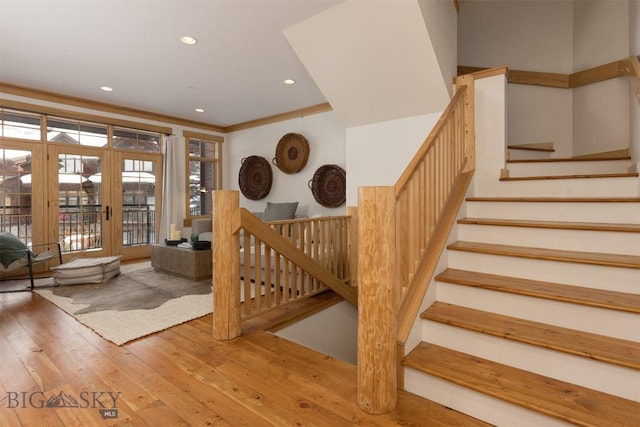 stairs with recessed lighting, french doors, and hardwood / wood-style flooring