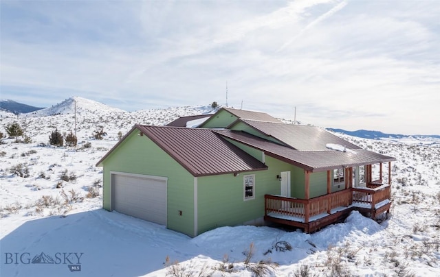 view of front of home featuring a standing seam roof, metal roof, and a mountain view