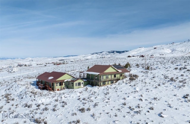 snowy aerial view featuring a mountain view