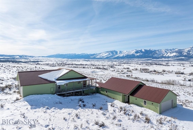 snowy aerial view featuring a mountain view