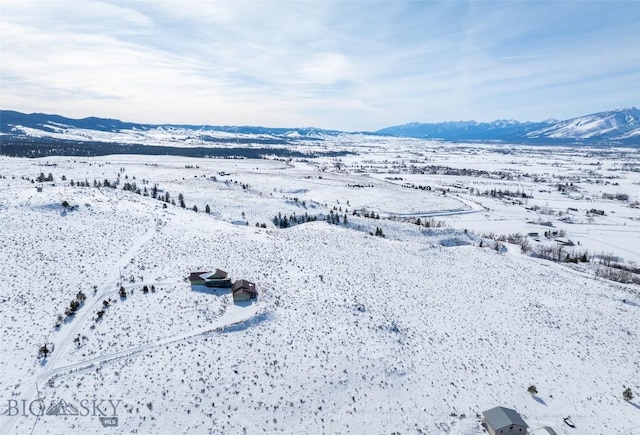 snowy aerial view with a mountain view