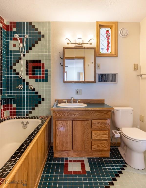 full bath featuring vanity, toilet, and tile patterned floors