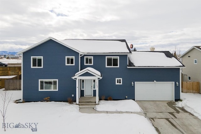 view of front of home featuring fence, driveway, and an attached garage