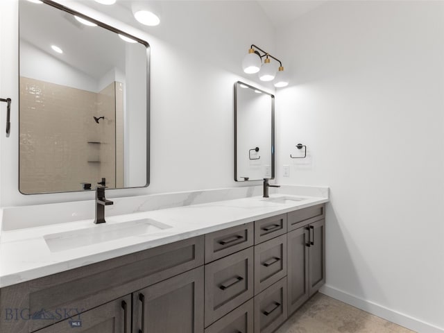 2820 S 30th Ave, Bozeman, MT 59718 - bathroom featuring double vanity, a tile shower, and baseboards